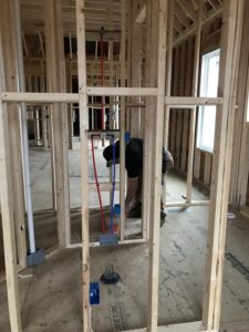 Joe sprays the floor in case the sheetrock covers a plug or switch.