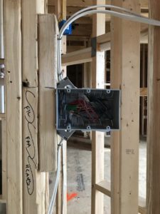 Joe adds a 2x4 piece to keep the box from bumping the door trim at finish.